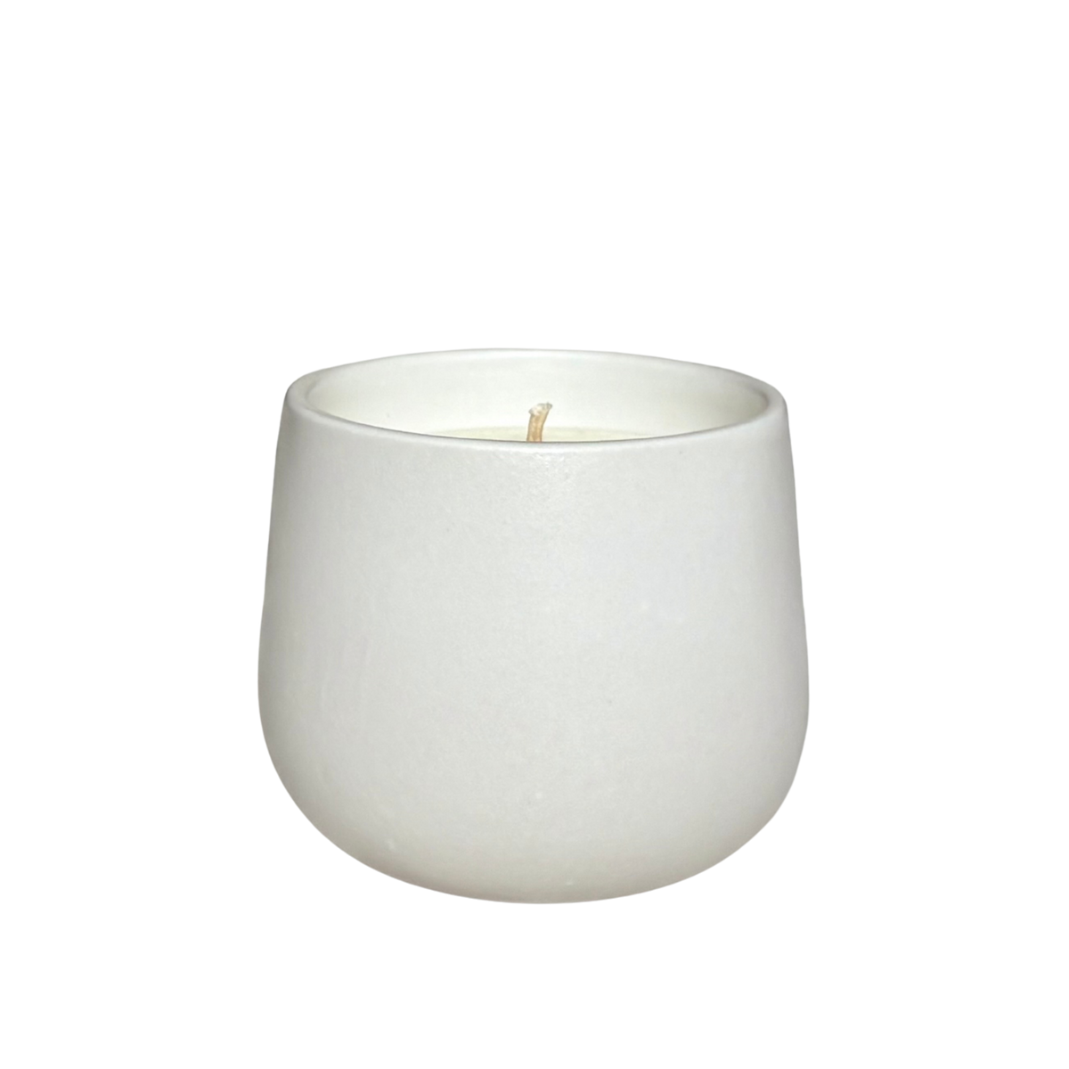 A white ceramic organic candle centered on a solid white background.
