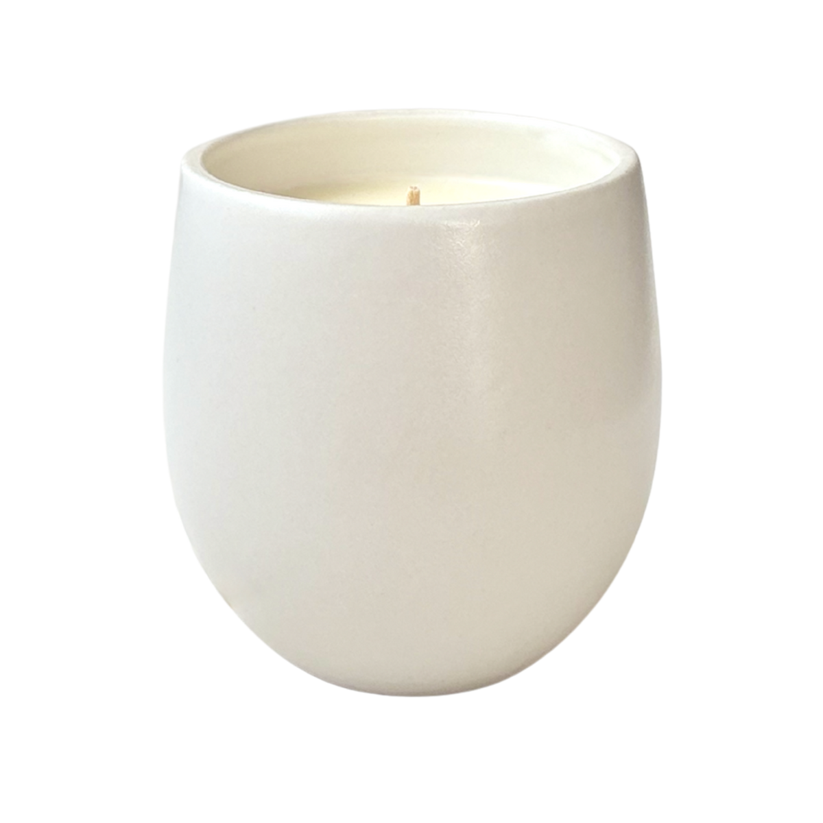 A white organic ceramic candle shown against a neutral background.