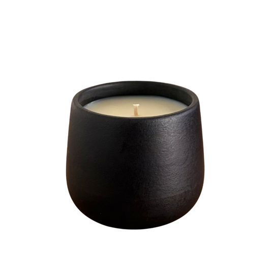 Black organic candle on a neutral background