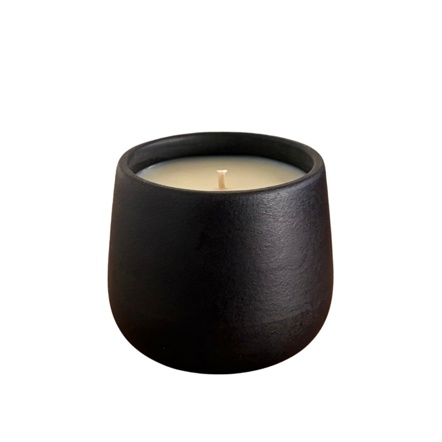 Black organic candle on a neutral background